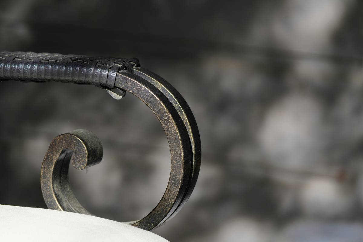 A decorative, swirled metal railing section.