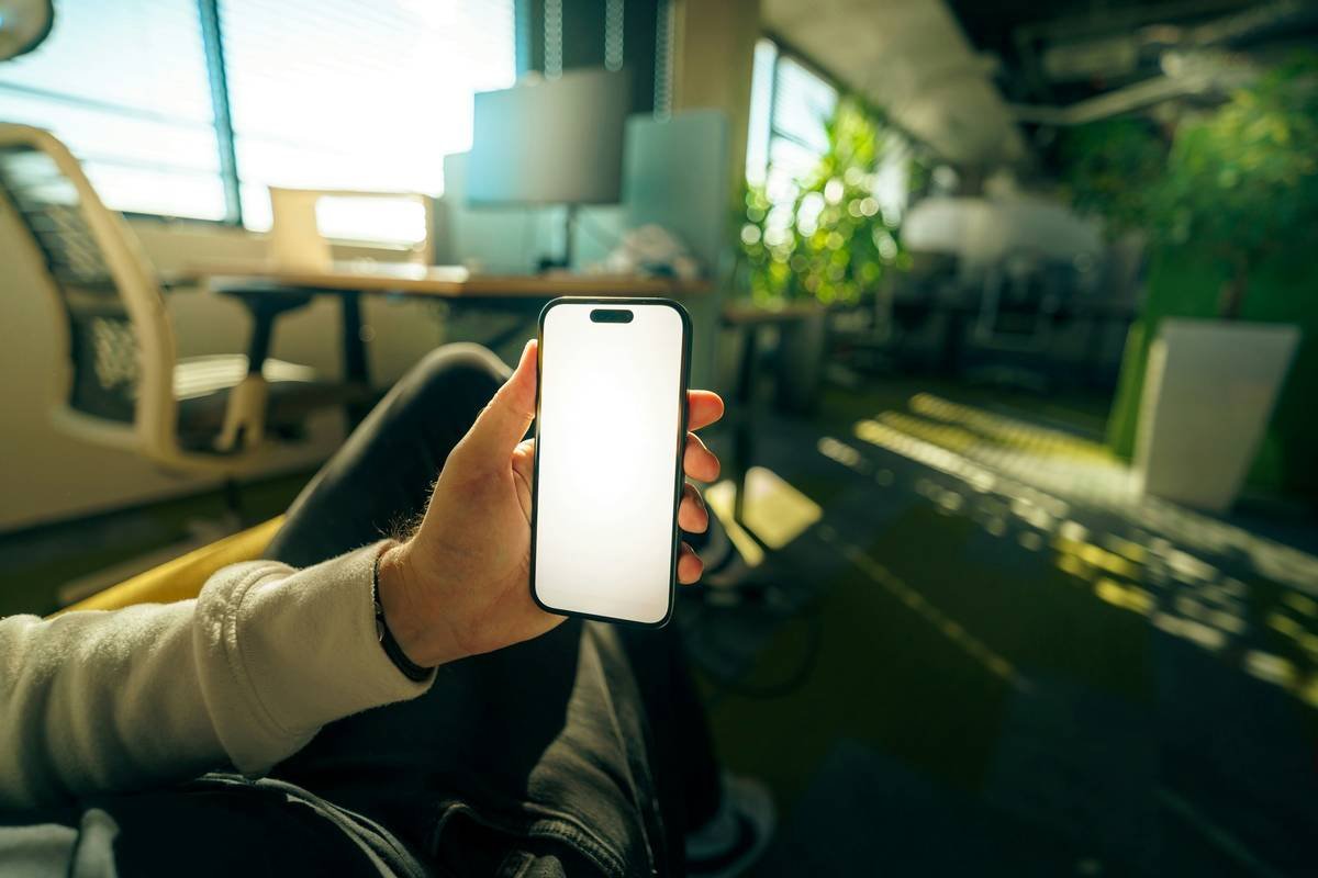 Side-by-side comparison showing accurate vs inaccurate AI-generated smartphone mockups. Left: photorealistic iPhone 15 in matte black case on desk. Right: AI-generated version with misplaced camera bump, floating screen, and incorrect button placement.